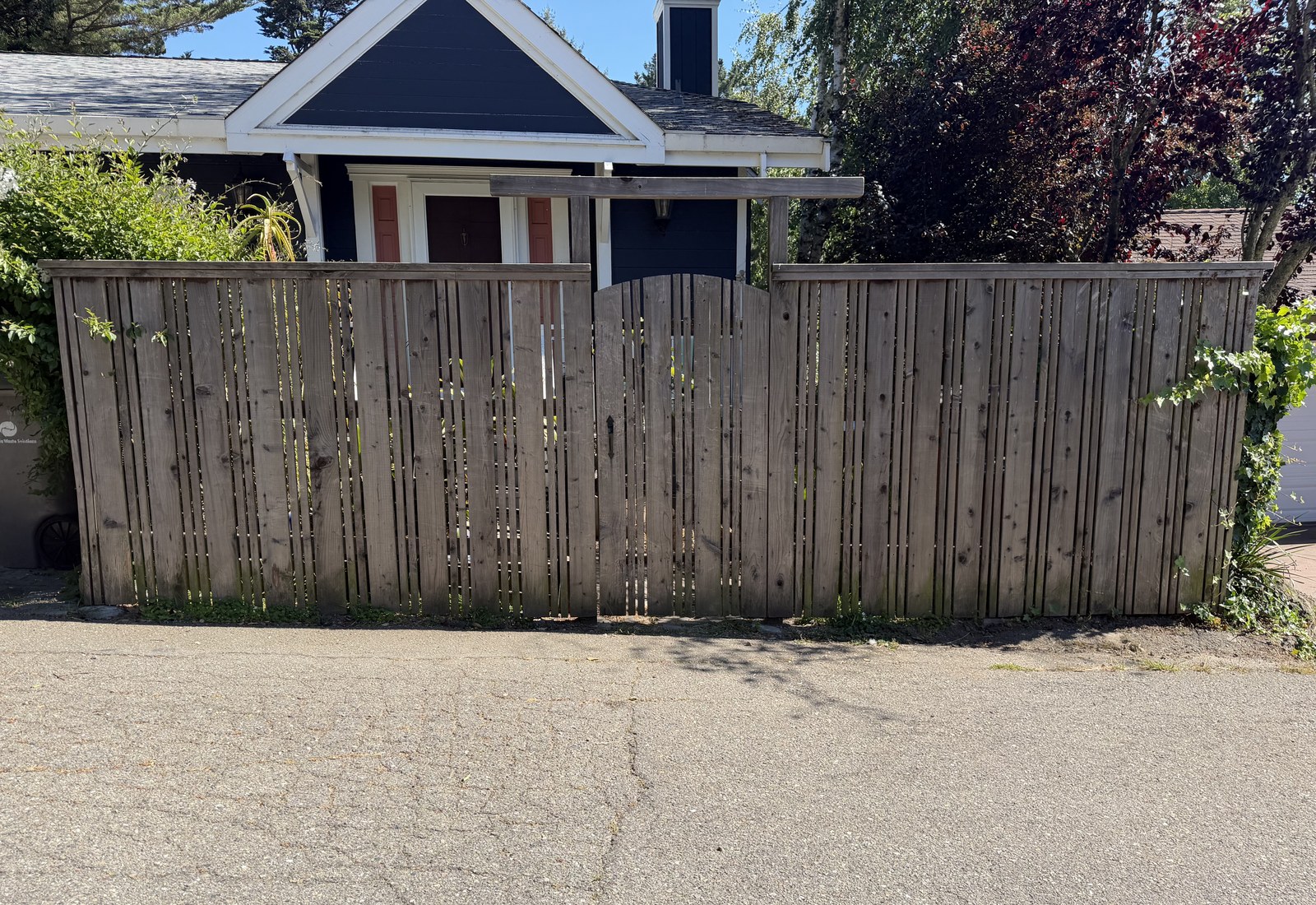 Faded natural-tone privacy fence before restoration