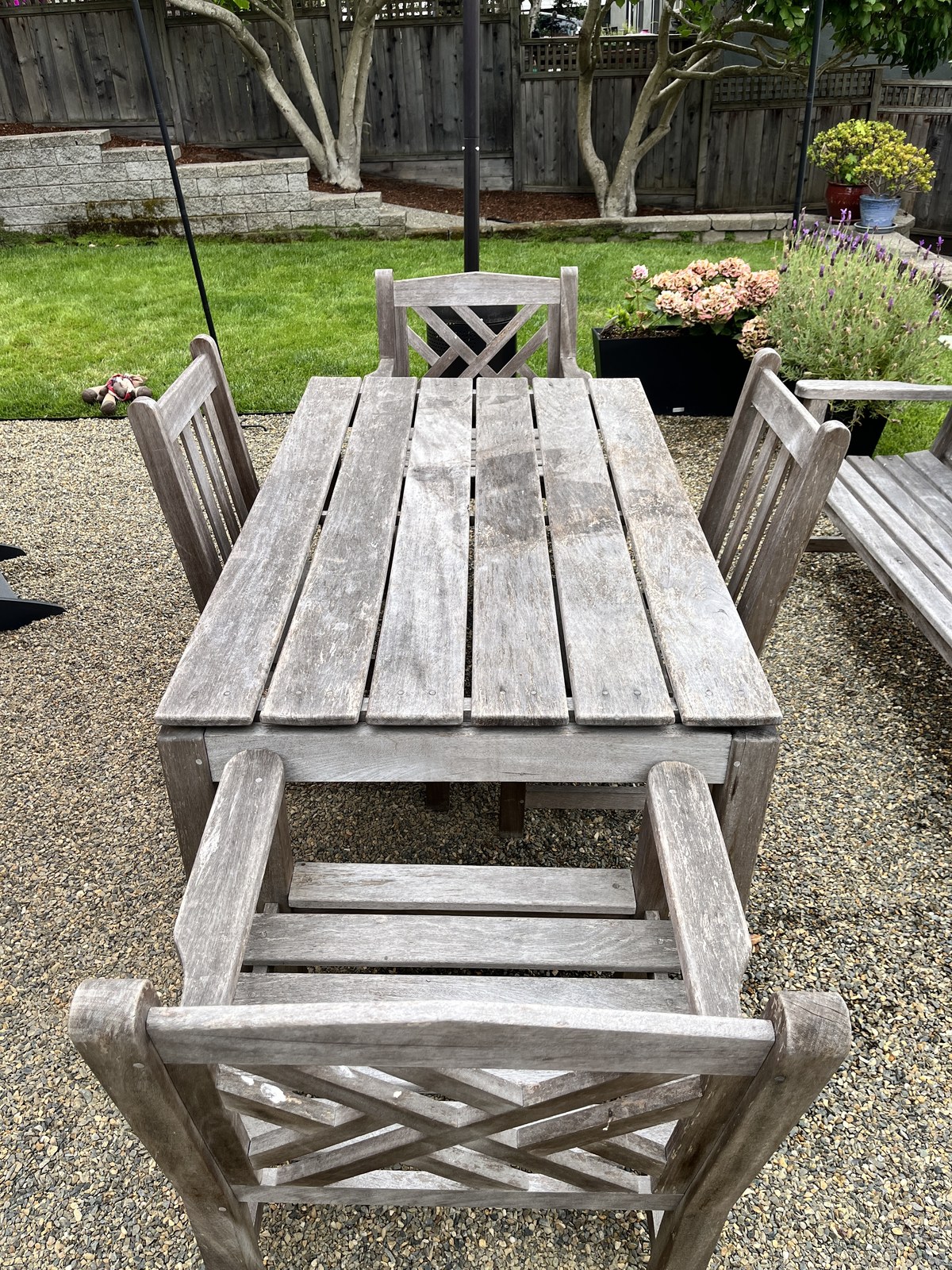 Weathered grey patio dining table and chairs before restoration