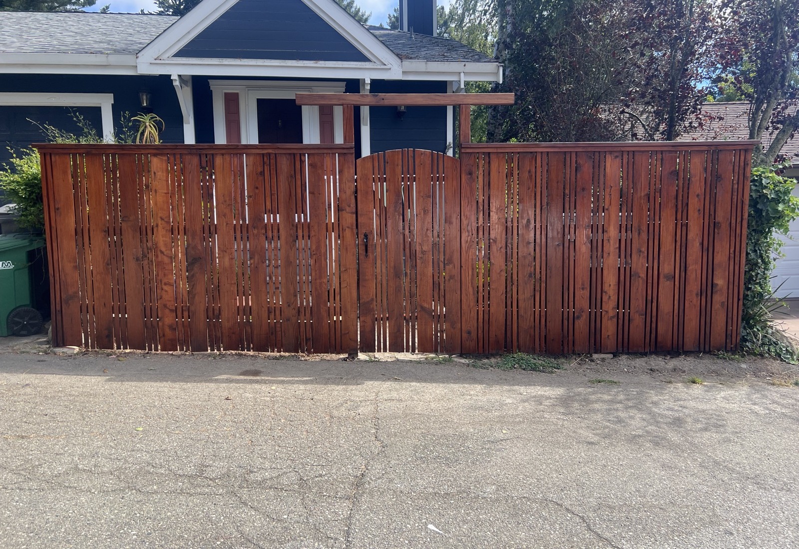 Same privacy fence refinished with a rich reddish stain